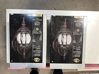 Two unopened boxes of Hampton Bay outdoor wall lanterns