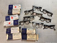 Overview of ten safety glasses pairs and six branded boxes