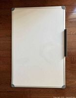 Front view of full whiteboard showing frame, corner caps and tray