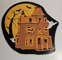 Front view of die-cut haunted house decoration