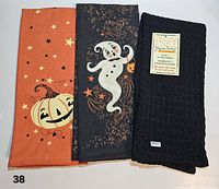 Front view of all three Halloween-themed tea towels