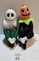 Front view of both knee-hugger dolls seated