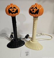 Front view of both window candles with pumpkin tops attached