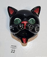 Front view of black cat redware ashtray