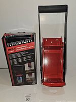 Front view of can crusher alongside branded retail box