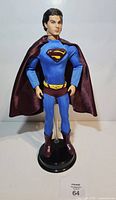 Full front view of Superman Returns Ken doll on stand