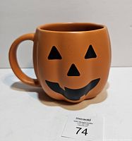 Front view showing jack-o-lantern face and overall mug shape