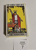 Closed tuck box front showing The Magician card art