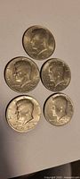 Group of five Kennedy half dollars, obverse side up