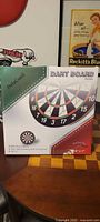 Front of boxed flocked dartboard set