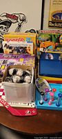 Overall lot showing game boxes, puzzle trays, giveaway balls