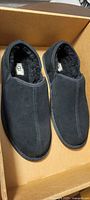 Top view of pair of black UGG Scuff Romeo II slippers showing suede upper and wool lining