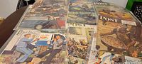 Wide view of all 10 magazine covers laid out on table