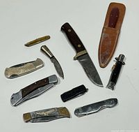 Overview of ten knives and sheath