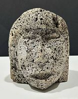 Front view of carved face sculpture