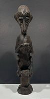 Full front view of carved wood African tribal figure sculpture