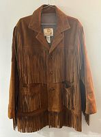 Full frontal view of jacket on hanger showing fringe and pockets