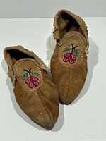 Top view of both moccasins showing overall condition and beadwork