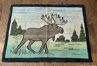 Full view of hooked rug showing moose scene and overall condition
