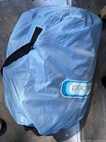 Light blue Aerobed carry bag containing air mattress