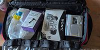 Bag with Sony recorder, Sony HF tape pack, microphone box, cords