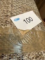 Close-up of rug surface and fringe with lot tag