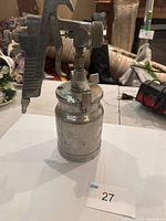 Left side view of Craftsman paint sprayer showing trigger, body and attached paint cup