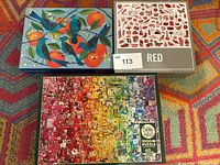 Group shot of three boxed 1000-piece puzzles