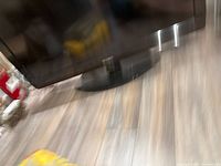 Front lower portion of Sharp TV on stand