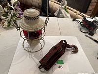 Lantern beside pulley on table