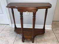 Front angled view showing top shape, legs, shelf