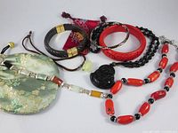 Group shot of all five jewellery pieces and pouches