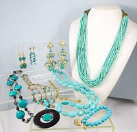 Overall lot showing necklaces, bracelets, earrings on display bust and acrylic stand