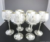 Front view of all six silver-plated engraved goblets