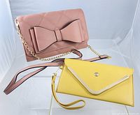 Overview of both items: pink shoulder bag with bow and yellow wristlet