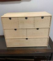 Front view of sealed six-drawer birch mini chest