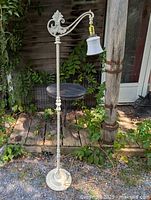 Full view of white cast iron bridge floor lamp showing entire height and base