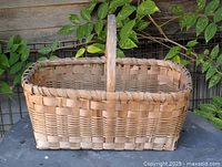 Front angled view of woven wood splint market basket