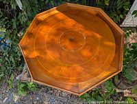 Full view of octagonal crokinole board outdoors