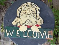 Front view of entire wooden dog welcome sign showing design and wear