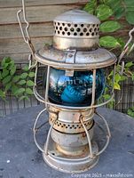 Front view of Piper CPR lantern showing blue globe and metal cage