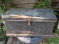 Front view of closed pine toolbox showing overall form, finish, and latch