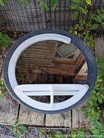 Front view of round mirror with shelf