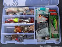 Overall view of open Plano tackle box with assorted lures and tackle