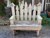 Front view of wooden garden bench showing full structure and wear