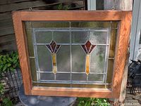 Full view of stained glass window in frame outdoors