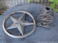 Cast iron star plaque and coffee grinder body on tabletop