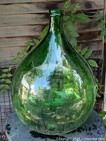 Full view of green glass demi-john front