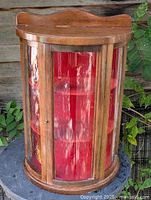 Front view of wooden curved glass display cabinet closed