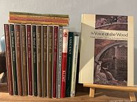 Full group of books on shelf including Time-Life volumes, catalogues, monographs, and first-edition book on stand